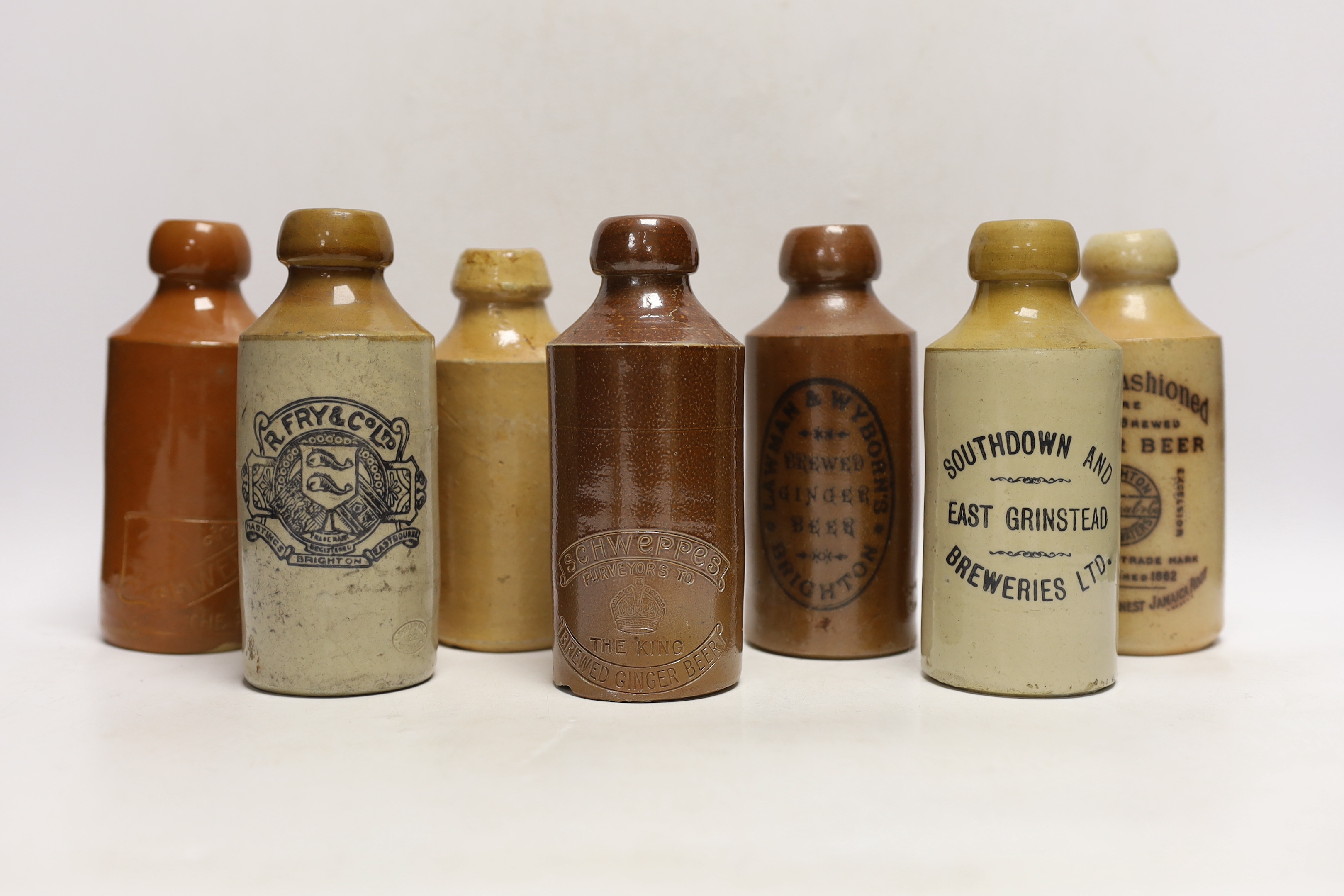 Early 20th century stoneware ginger beer bottles, two of Brighton, one of London, one of East Grinstead and four others